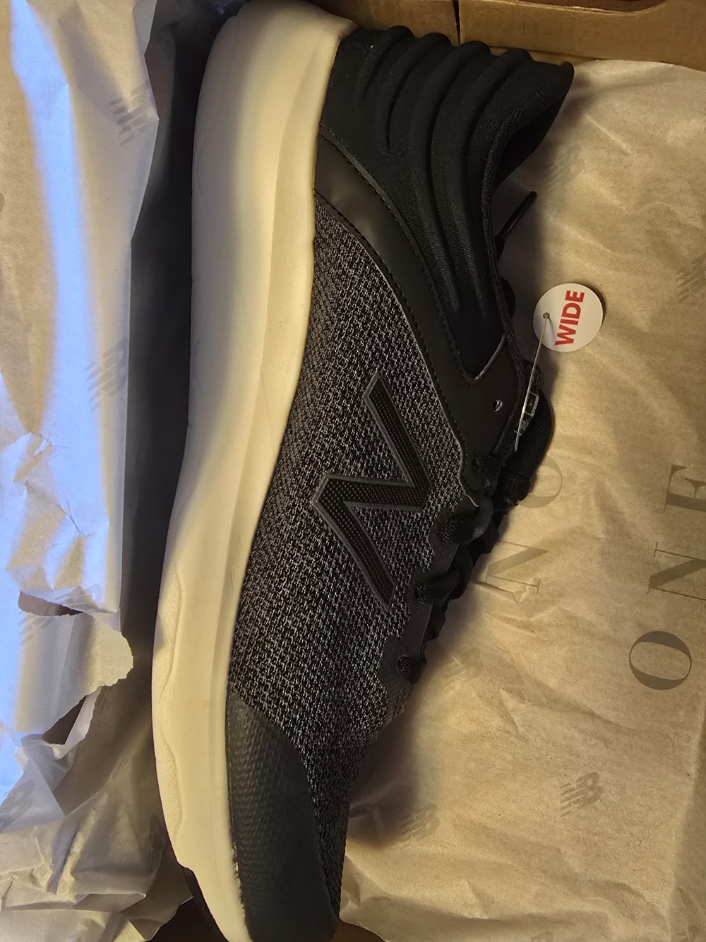 New Balance Men's Athletic Sneaker in Black and Cream
